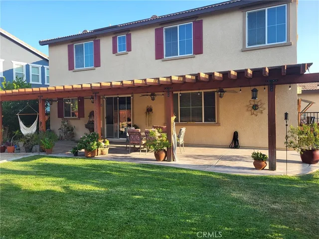 a view of a house with backyard porch and sitting area