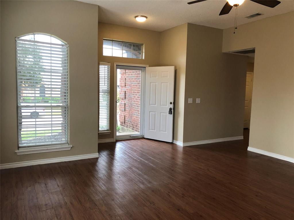 8301 Bells Street Frisco, TX 75035 - Photo 4 of 24 a view of an empty room with wooden floor and a window