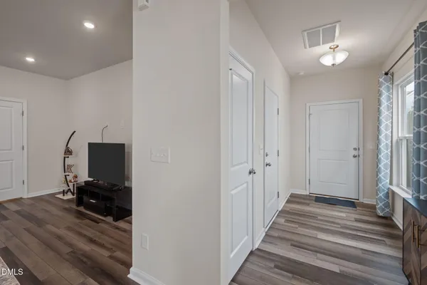 a living room with furniture and a wooden floor