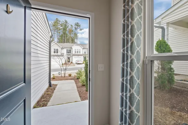 a dining room with wooden floor a chandelier a wooden table and chairs