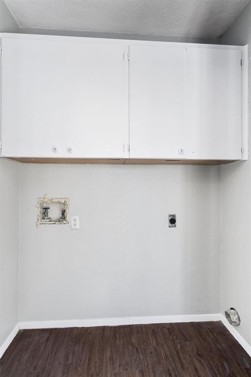 1711 Rawhide Loop Round Rock, TX 78681 - Photo 12 of 14 Washroom with a textured ceiling, cabinet space, hookup for a washing machine, dark wood finished floors, and electric dryer hookup