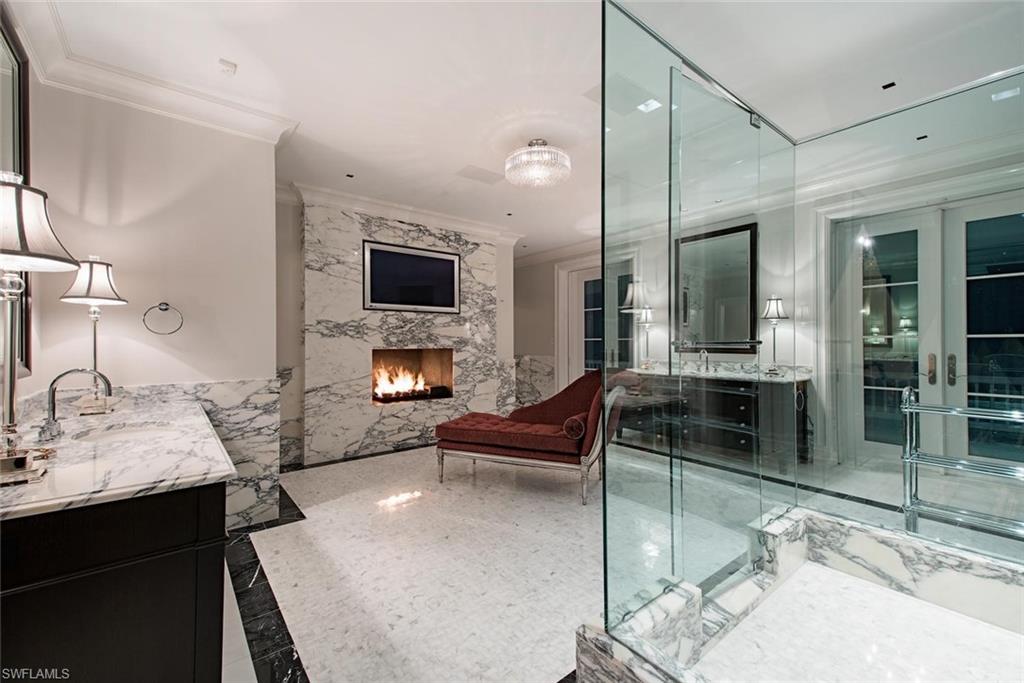 2500 Gordon Drive Naples, FL 34102 - Photo 18 of 25 a living room with furniture and a fireplace