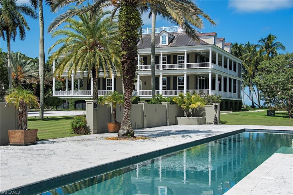 2500 Gordon Drive Naples, FL 34102 - Photo 25 of 25 a front view of a house with swimming pool having outdoor seating