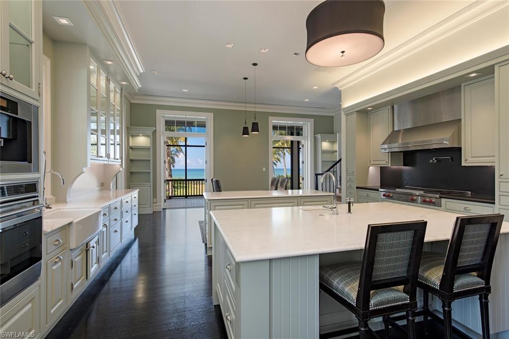 2500 Gordon Drive Naples, FL 34102 - Photo 6 of 25 a large kitchen with a table and chairs