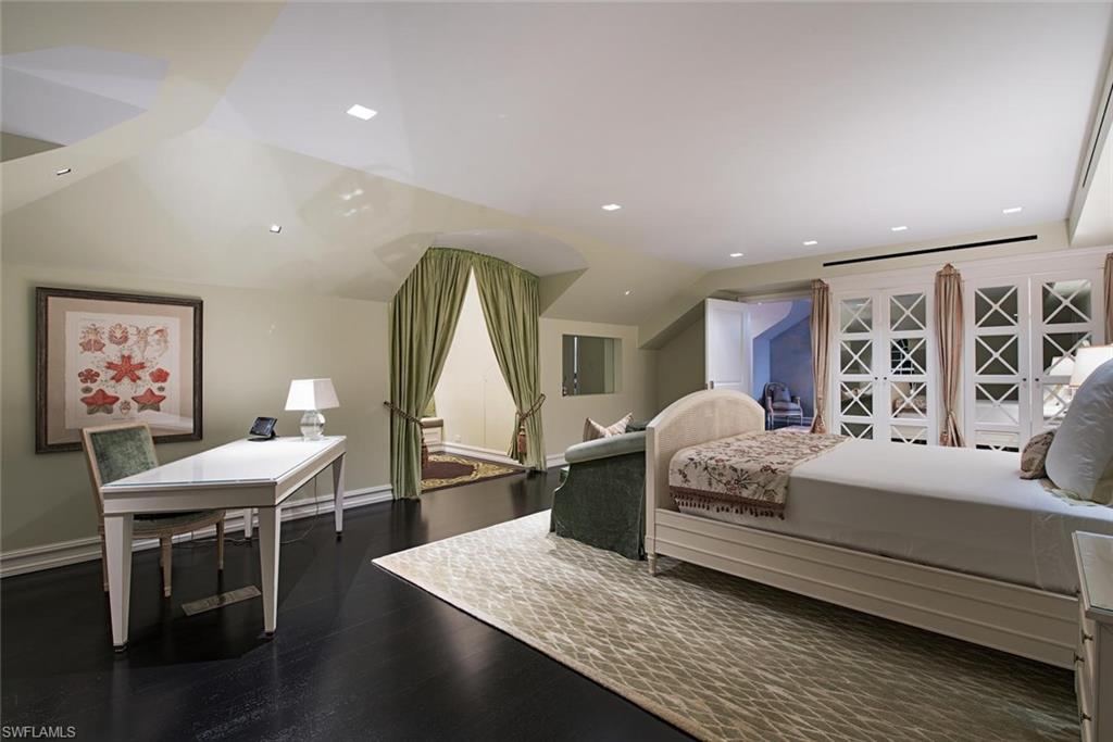 2500 Gordon Drive Naples, FL 34102 - Photo 8 of 25 a bedroom with a bed and a table