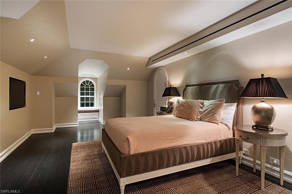 2500 Gordon Drive Naples, FL 34102 - Photo 10 of 25 a bedroom with a bed and wooden floor