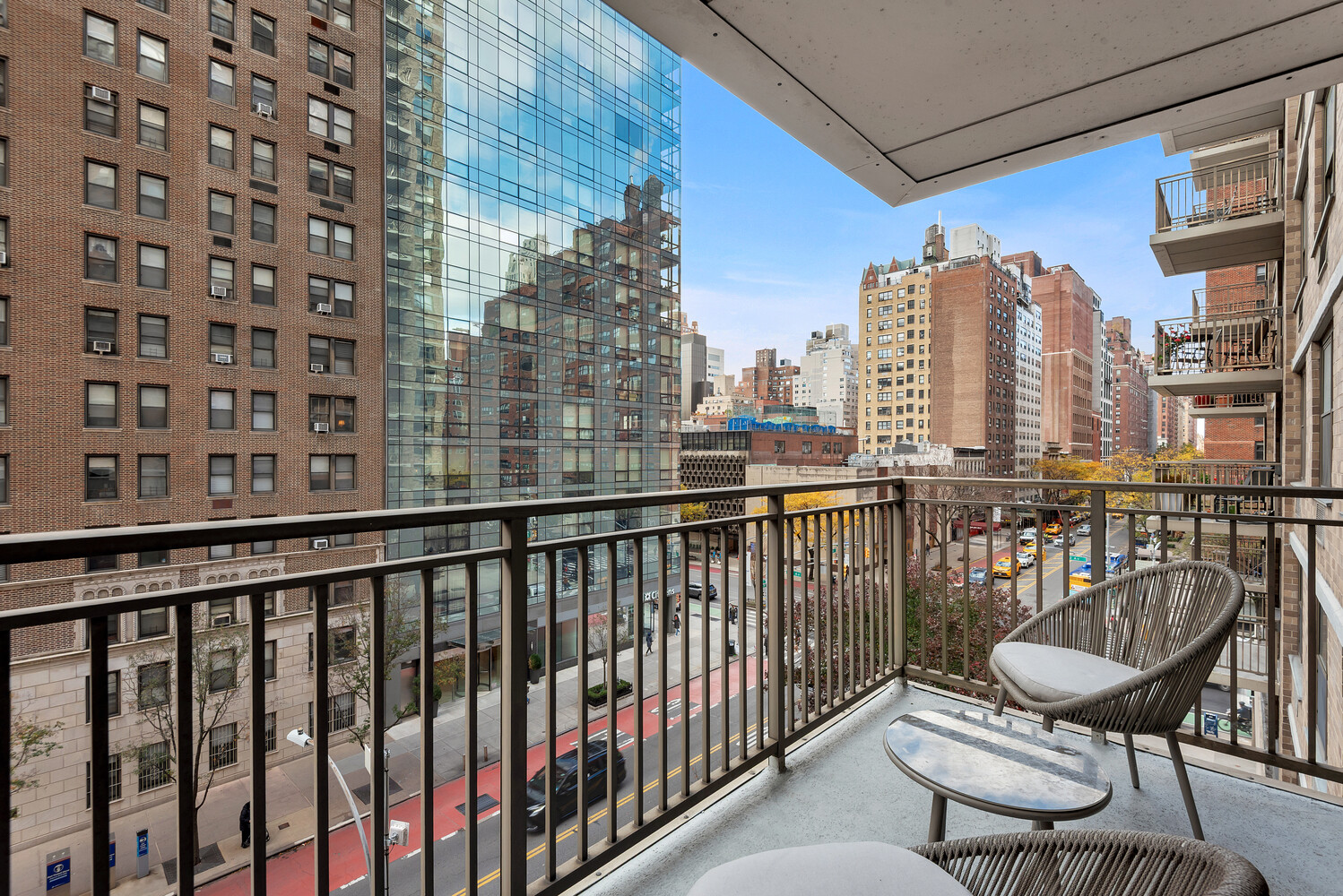 301 East 79th Street, Unit 5P Manhattan, NY 10075 - Photo 2 of 16 a view of a balcony with wooden chairs