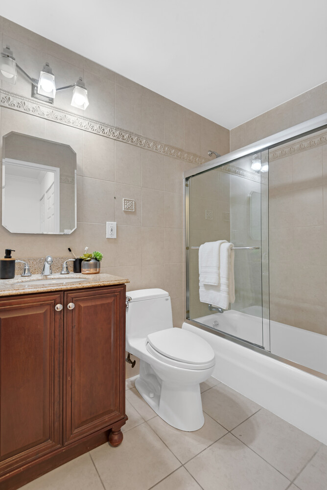 301 East 79th Street, Unit 5P Manhattan, NY 10075 - Photo 8 of 16 a bathroom with a sink toilet and shower