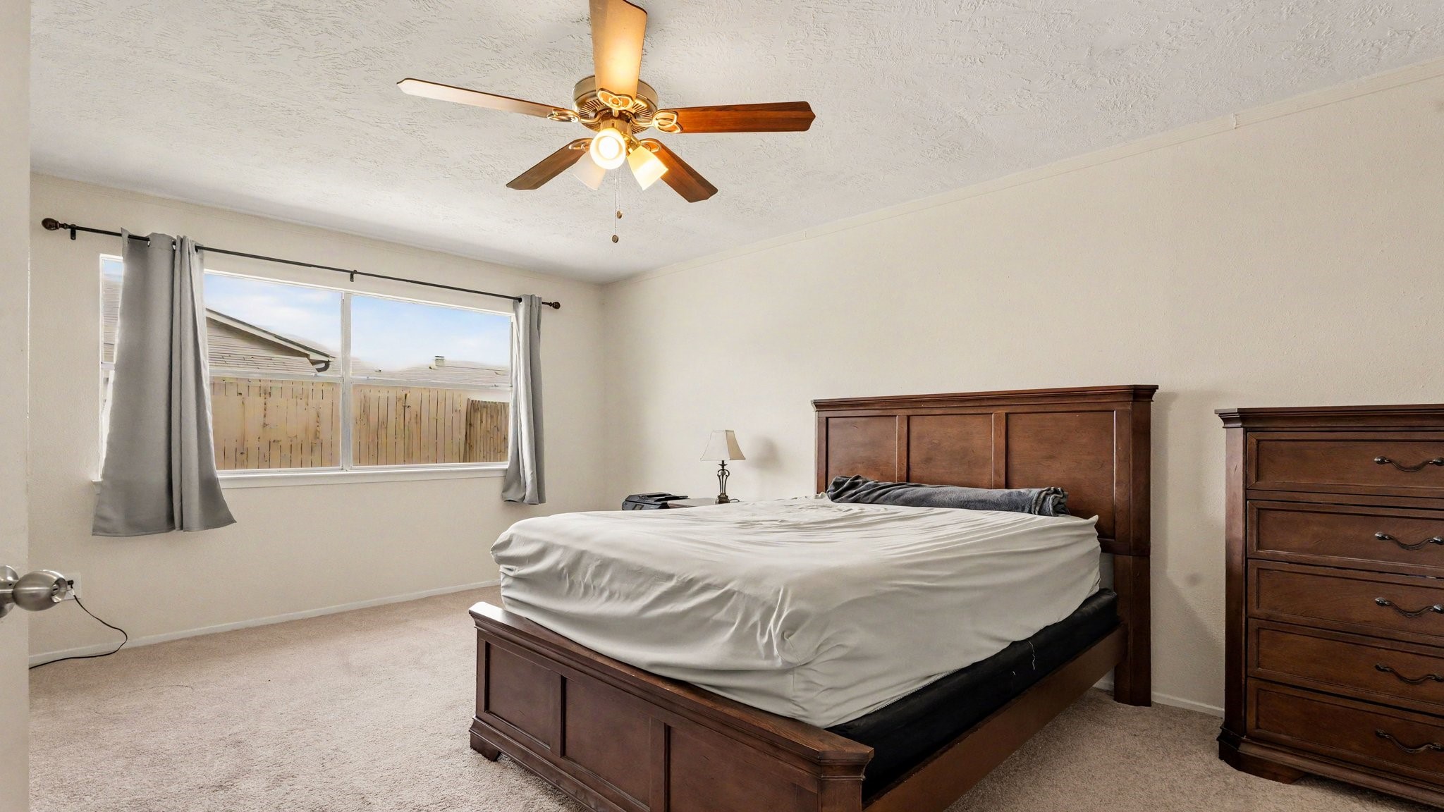 1506 Holbech Lane Channelview, TX 77530 - Photo 10 of 21 a bedroom with a bed and a chandelier