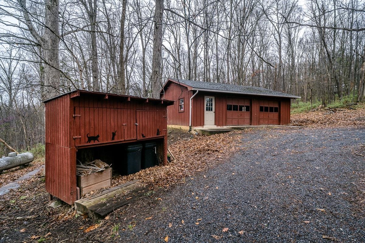 188 New Market Reservoir Road New Market, VA 22844 - Photo 43 of 61 Charming red outbuilding in the woods.