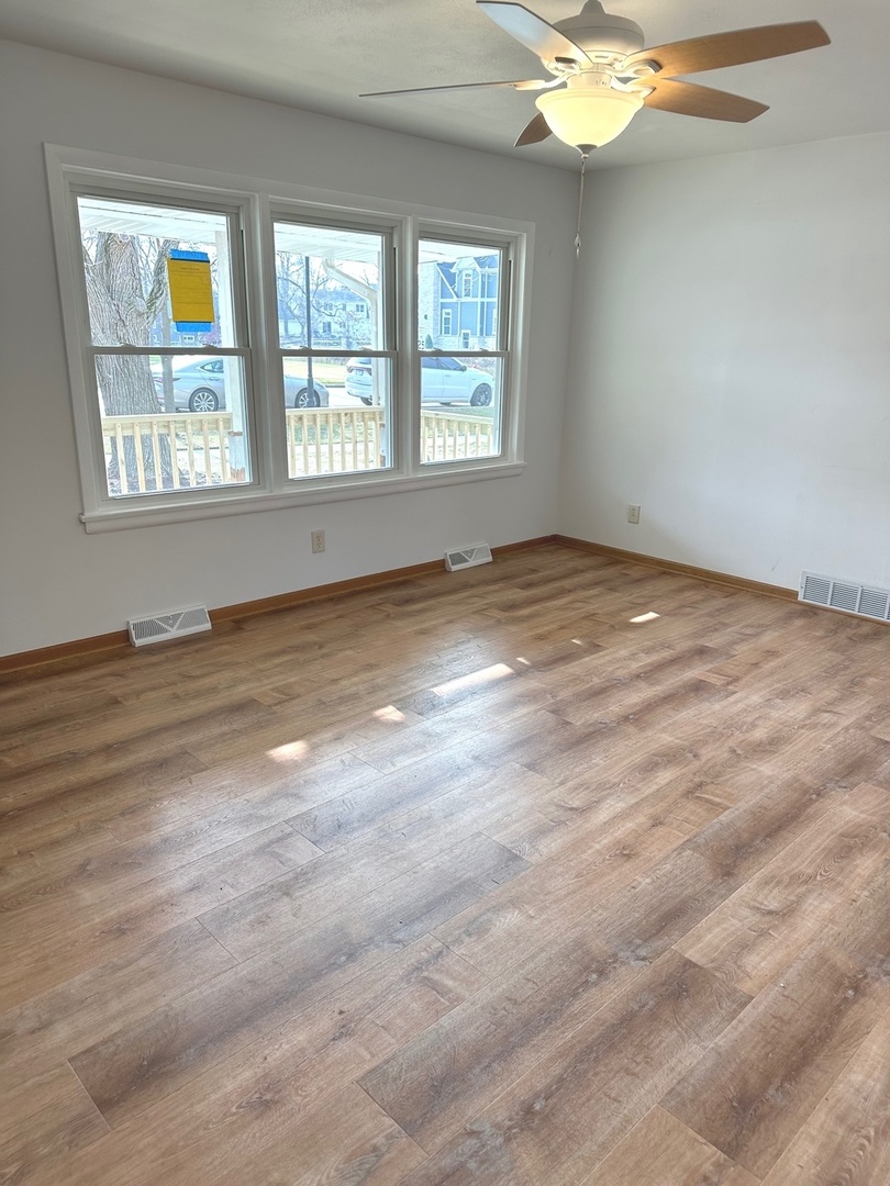 249 West Nebraska Street Frankfort, IL 60423 - Photo 5 of 18 a view of an empty room with wooden floor and a window