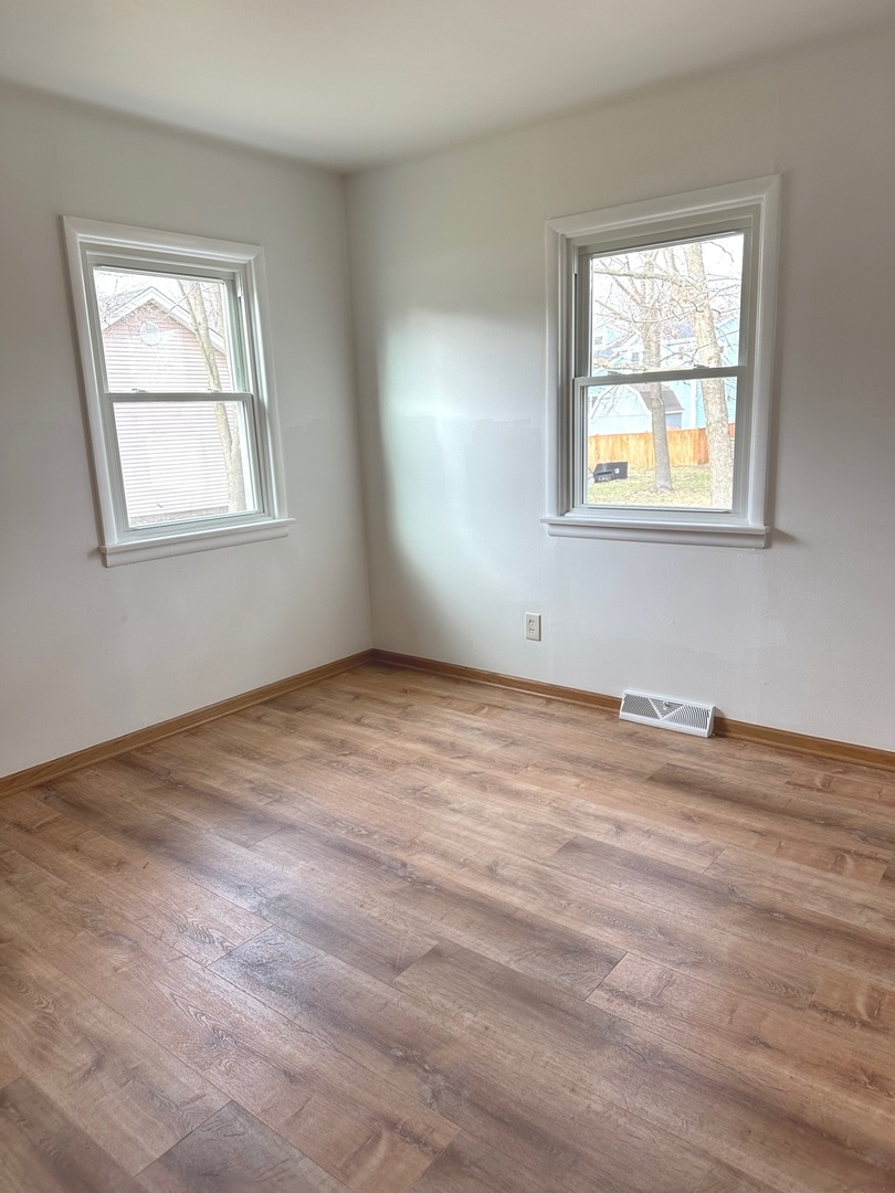 249 West Nebraska Street Frankfort, IL 60423 - Photo 9 of 18 a view of an empty room with wooden floor and a window