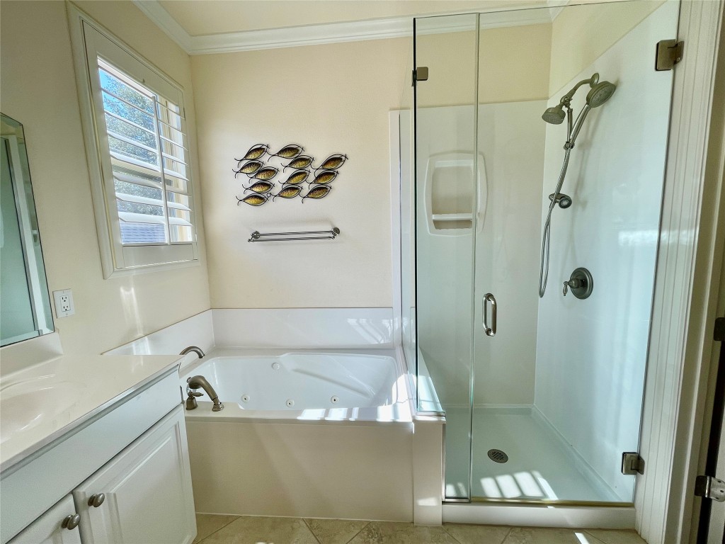 20603 Highland Lake Loop Lago Vista, TX 78645 - Photo 15 of 37 a bathroom with a tub a window and a shower