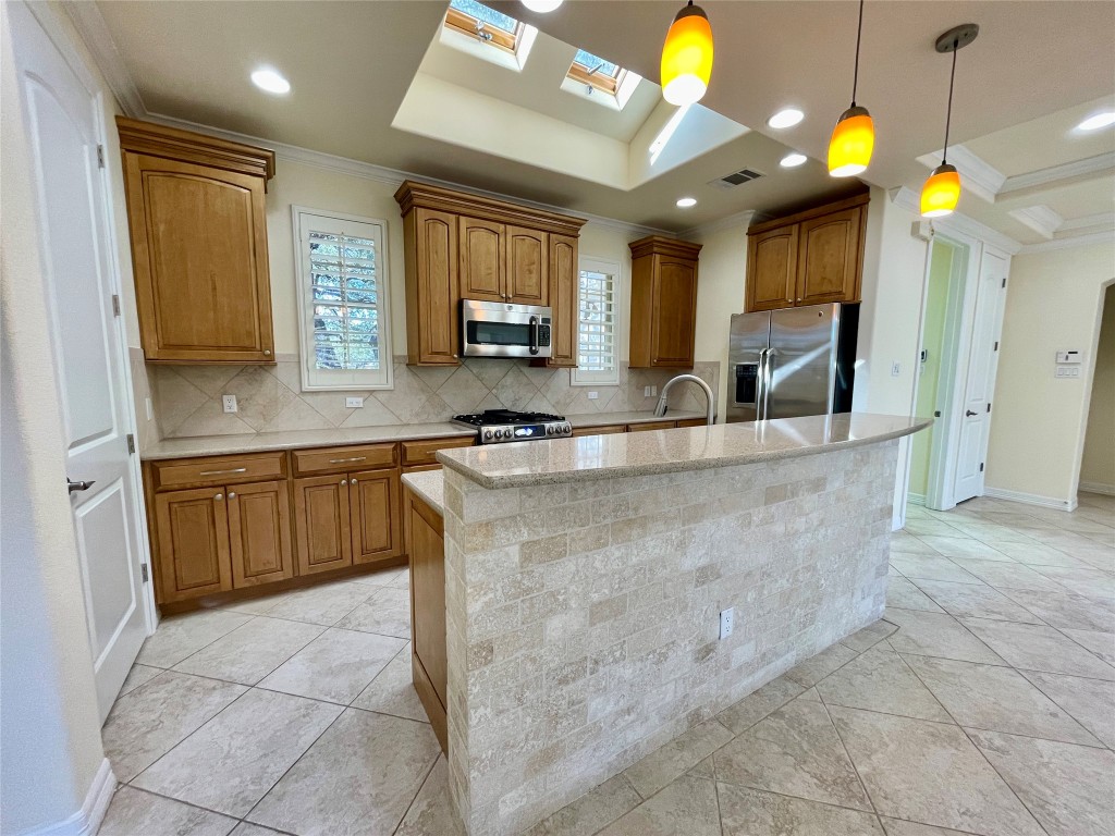 20603 Highland Lake Loop Lago Vista, TX 78645 - Photo 7 of 37 a kitchen with kitchen island granite countertop a stove a sink a counter top space and cabinets