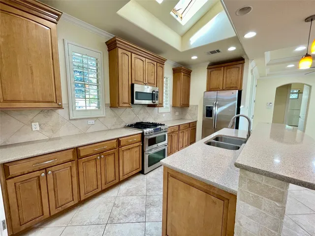 a kitchen that has a sink and a stove in it