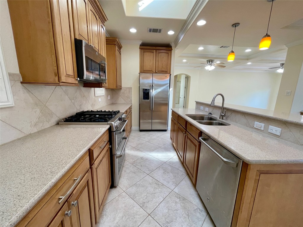 20603 Highland Lake Loop Lago Vista, TX 78645 - Photo 9 of 37 a kitchen that has a sink and a stove in it