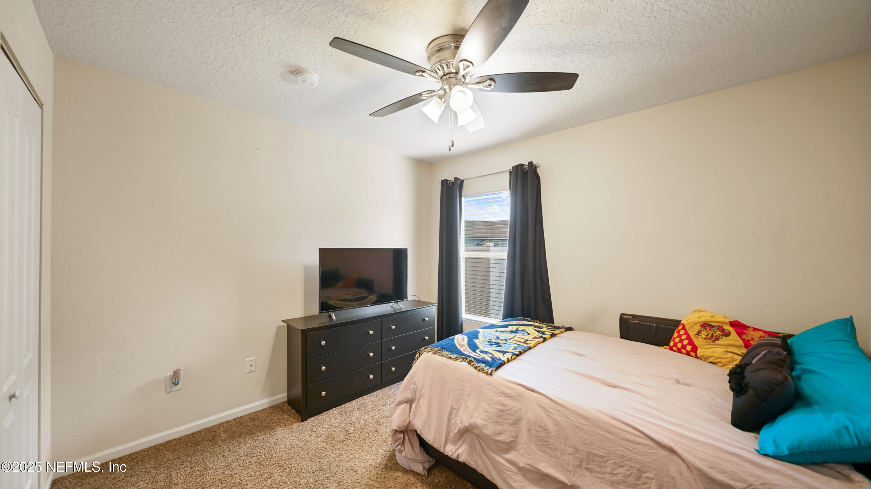 75 Pullman Circle St. Augustine, FL 32084 - Photo 13 of 25 a bedroom with a bed and a flat tv screen on a dresser