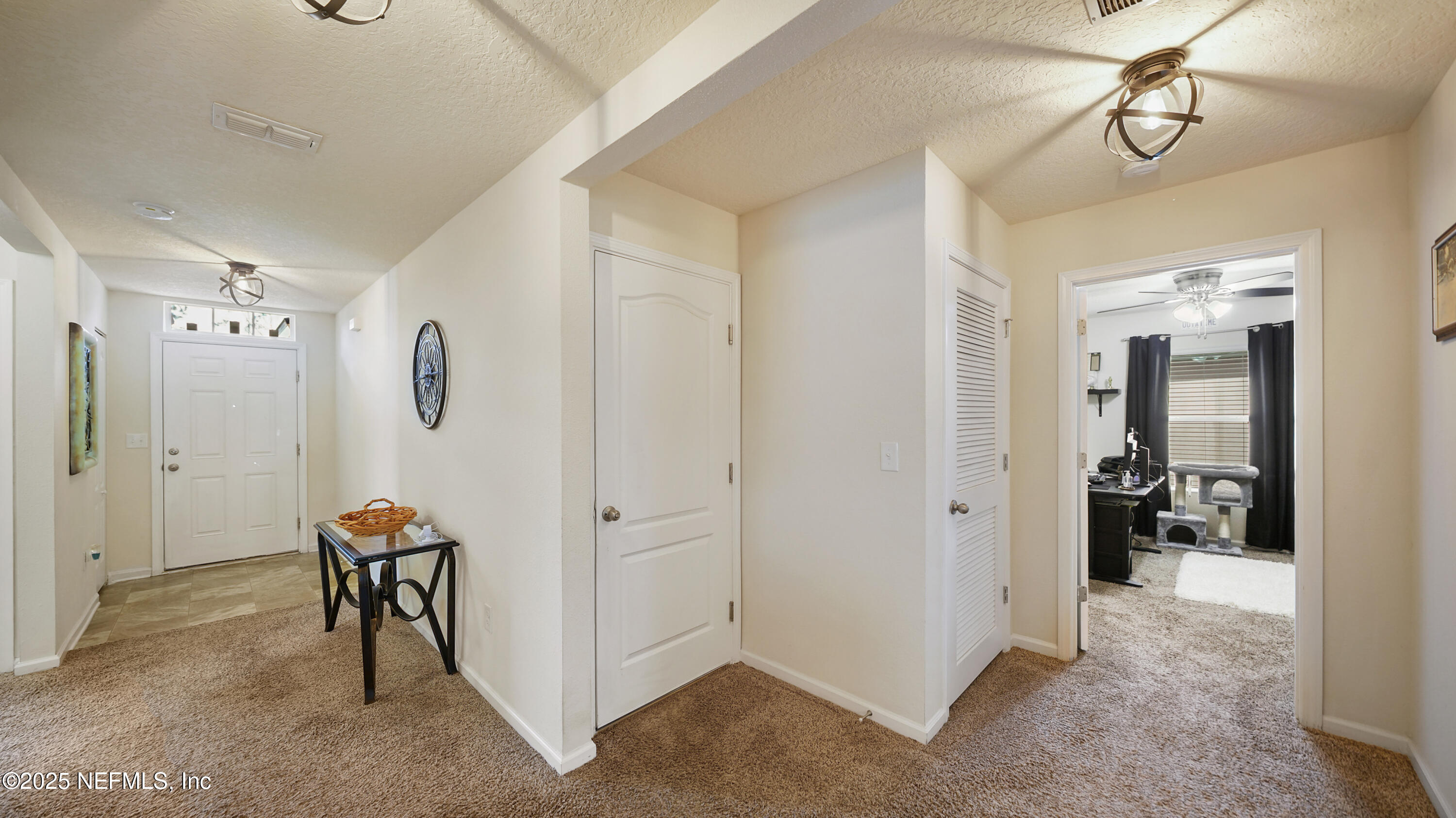 75 Pullman Circle St. Augustine, FL 32084 - Photo 16 of 25 a view of a hallway with living room and furniture