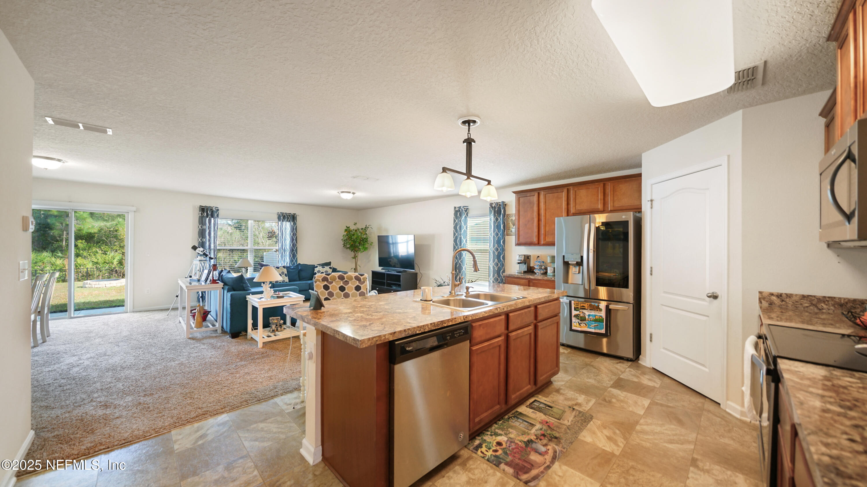 75 Pullman Circle St. Augustine, FL 32084 - Photo 3 of 25 a large kitchen with a counter space a sink appliances and living room