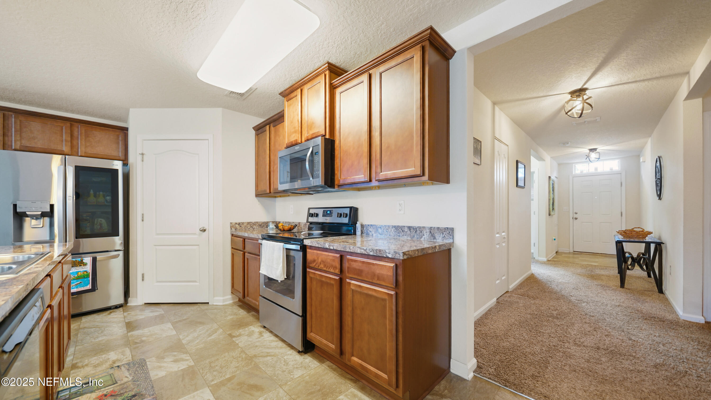 75 Pullman Circle St. Augustine, FL 32084 - Photo 4 of 25 a kitchen with stainless steel appliances granite countertop a refrigerator and a stove top oven
