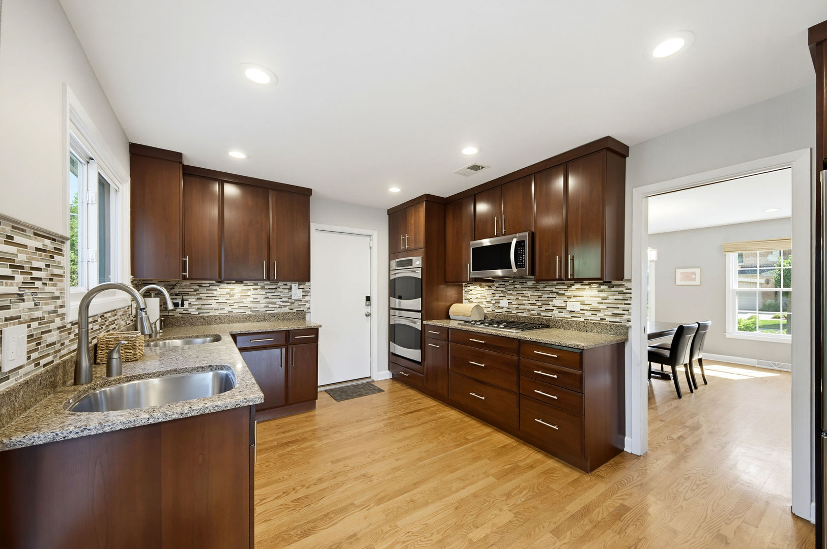 9200 Ridgeway Avenue Evanston, IL 60203 - Photo 7 of 33 a kitchen with stainless steel appliances granite countertop a sink stove and cabinets