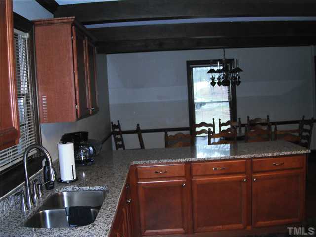 800 Ivanhoe Drive Raleigh, NC 27615 - Photo 6 of 19 a kitchen with sink a microwave and refrigerator