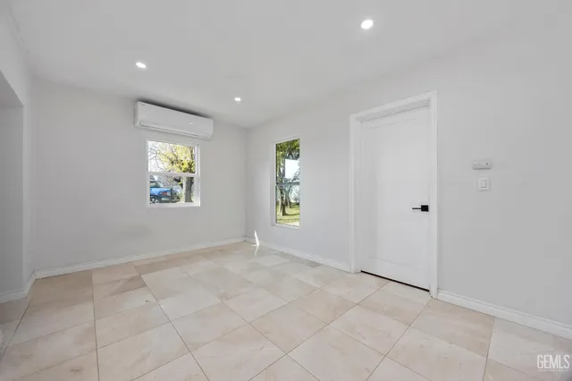 an empty room with windows and closet