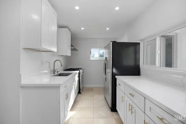 a kitchen with a sink and a refrigerator