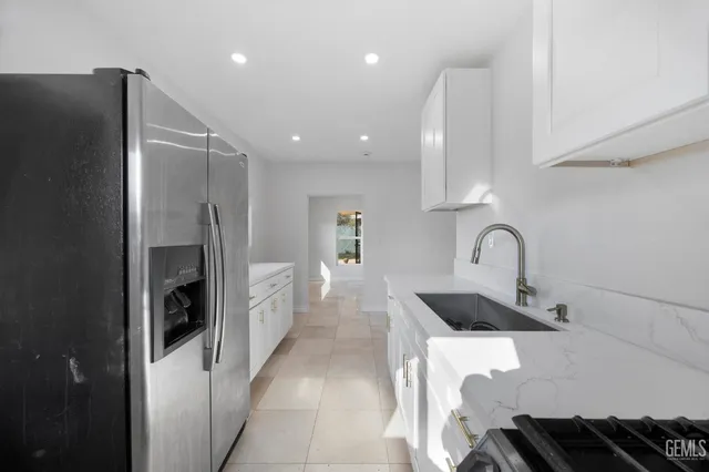 a kitchen with a refrigerator and cabinets