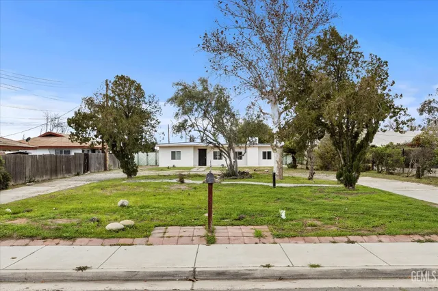 a front view of a house with swimming pool having outdoor seating