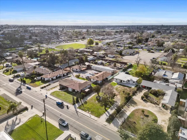 a view of a yard in front of a house with a large tree