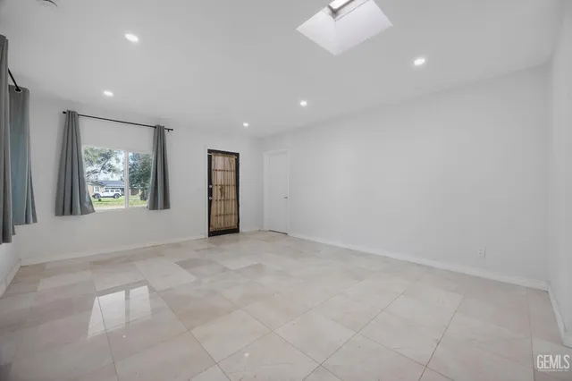 an empty room with entrance and windows