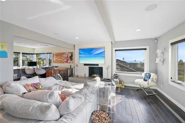 a living room with furniture fireplace and a large window