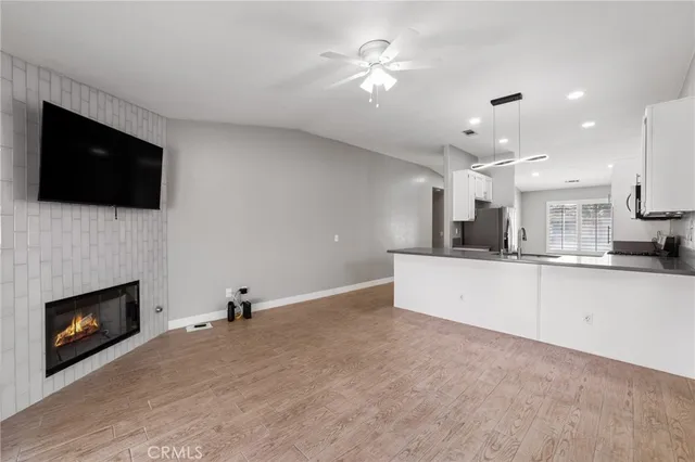 a view of an empty room with a fireplace and a window
