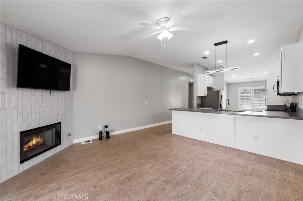 50855 Chiapas Drive Coachella, CA 92236 - Photo 12 of 34 a view of kitchen with kitchen island a fireplace wooden floor and a window