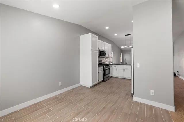 a kitchen with stainless steel appliances a stove sink microwave and cabinets