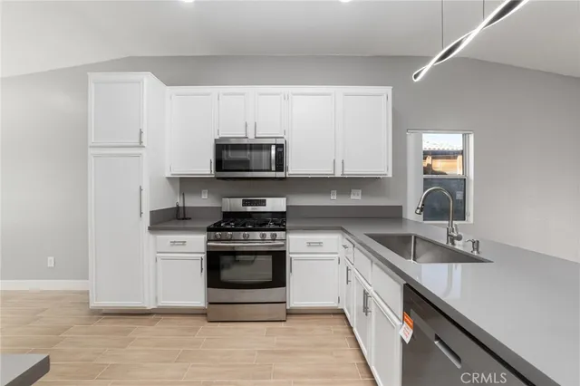 a kitchen with stainless steel appliances a refrigerator and a stove