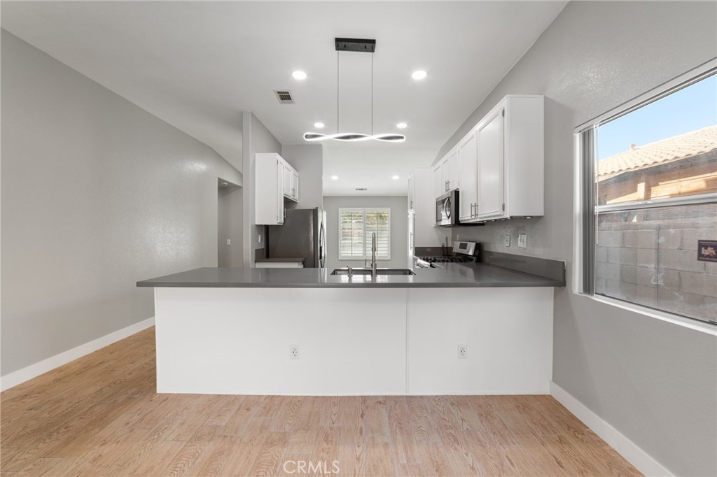 50855 Chiapas Drive Coachella, CA 92236 - Photo 20 of 34 a view of a kitchen with a sink and wooden floor