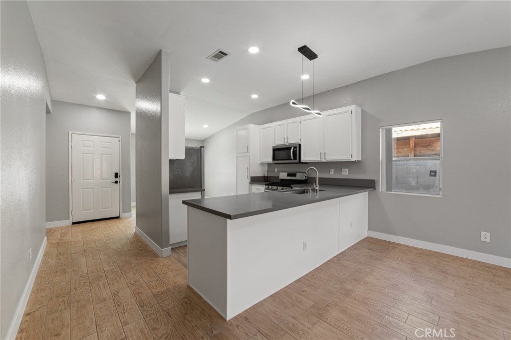 50855 Chiapas Drive Coachella, CA 92236 - Photo 21 of 34 a kitchen with stainless steel appliances kitchen island granite countertop a refrigerator and a sink
