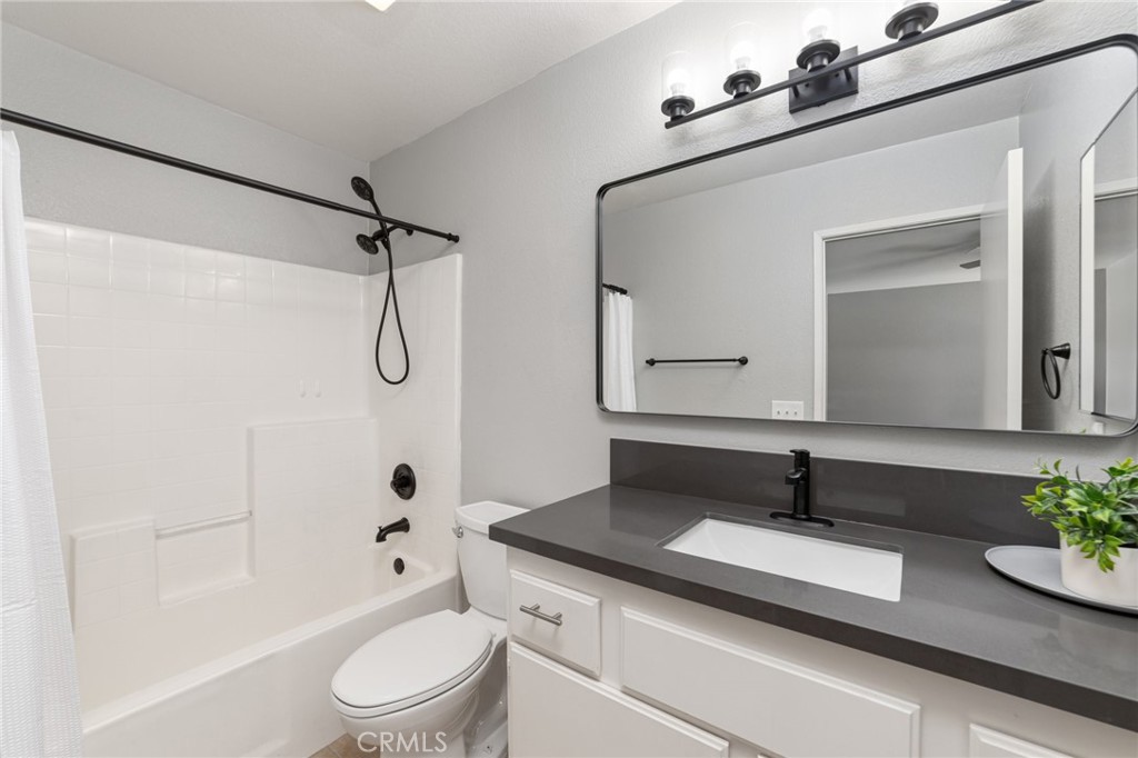 50855 Chiapas Drive Coachella, CA 92236 - Photo 24 of 34 a bathroom with a granite countertop sink toilet a mirror and shower