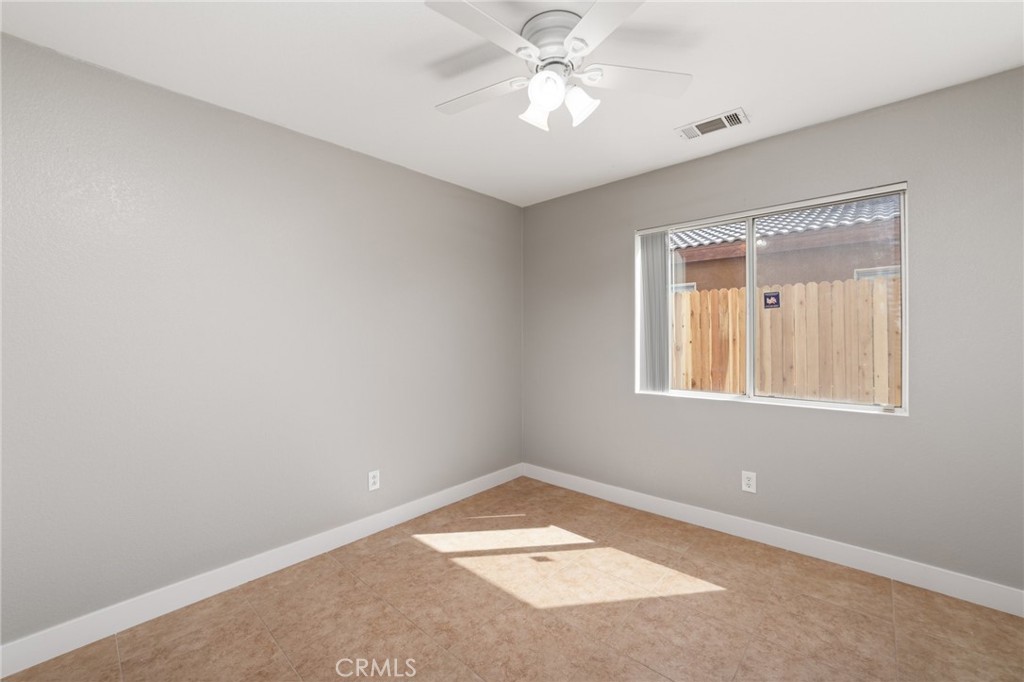 50855 Chiapas Drive Coachella, CA 92236 - Photo 25 of 34 an empty room with a window and a fan