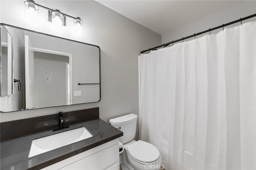 50855 Chiapas Drive Coachella, CA 92236 - Photo 27 of 34 a bathroom with a sink a toilet and a mirror