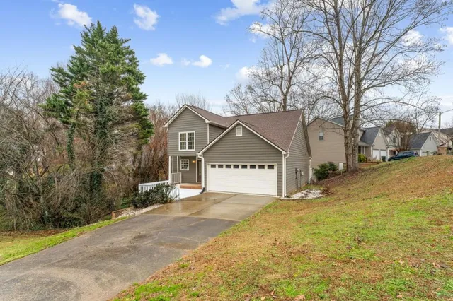a view of a house with a yard covered in snow