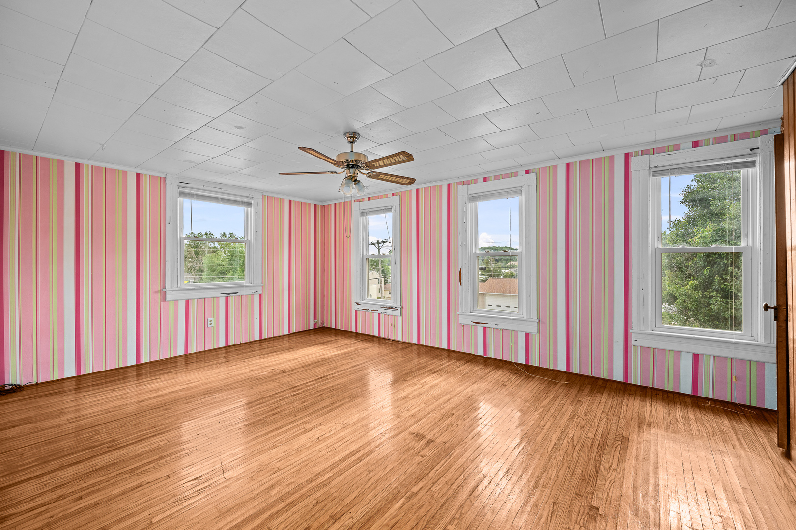 802 North High Street Port Byron, IL 61275 - Photo 35 of 43 a view of a livingroom with wooden floor window and a ceiling fan