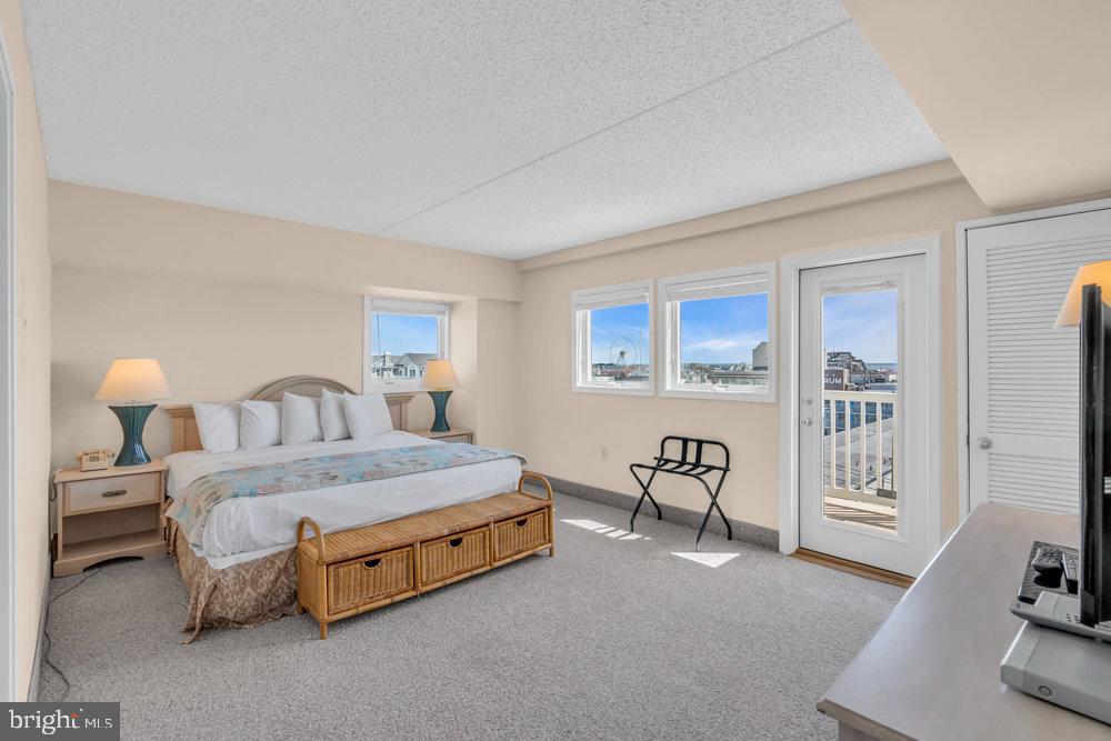 812 Ocean Avenue, Unit 420 Ocean City, NJ 08226 - Photo 12 of 20 a spacious bedroom with a bed and a couch