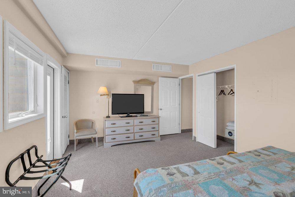 812 Ocean Avenue, Unit 420 Ocean City, NJ 08226 - Photo 14 of 20 a bedroom with furniture and flat screen tv