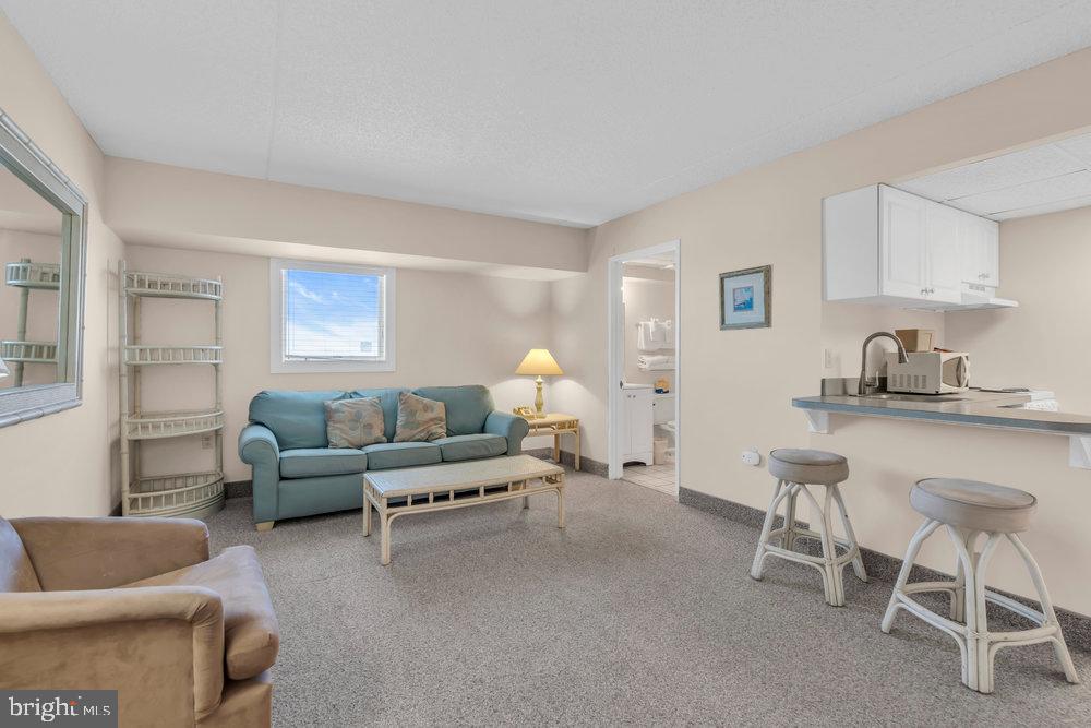 812 Ocean Avenue, Unit 420 Ocean City, NJ 08226 - Photo 4 of 20 a living room with furniture and a lamp