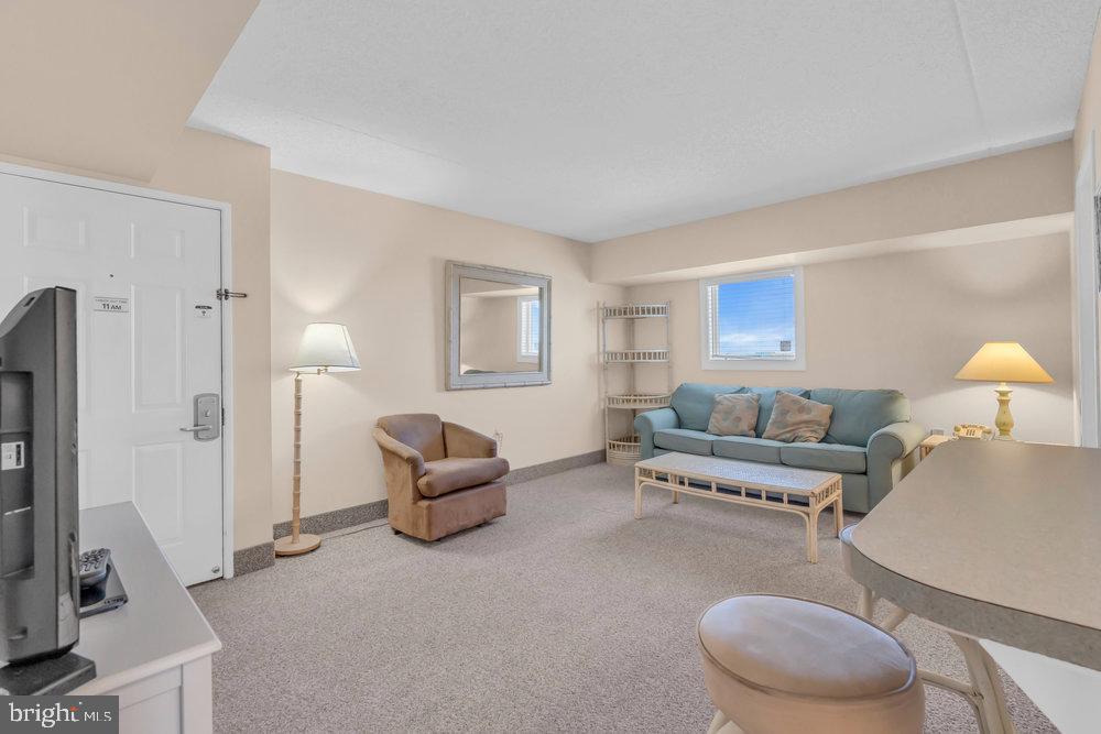812 Ocean Avenue, Unit 420 Ocean City, NJ 08226 - Photo 5 of 20 a living room with furniture and a flat screen tv