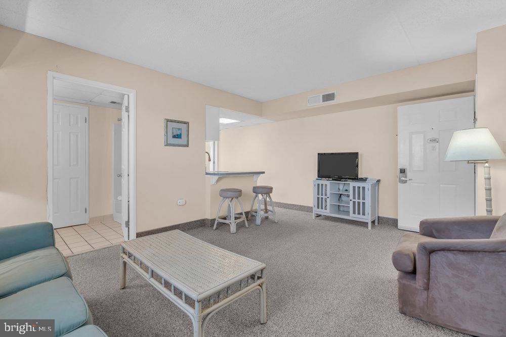 812 Ocean Avenue, Unit 420 Ocean City, NJ 08226 - Photo 6 of 20 a living room with furniture and a flat screen tv