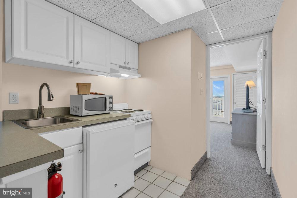 812 Ocean Avenue, Unit 420 Ocean City, NJ 08226 - Photo 7 of 20 a kitchen with a sink and cabinets